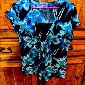 Gorgeous blouse with teals, white, and navy blue flower accents.